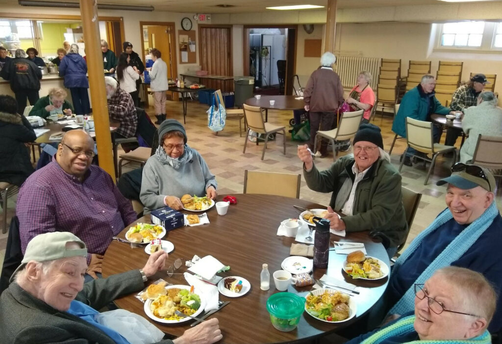 Picture of people getting food at Zion Community Commons